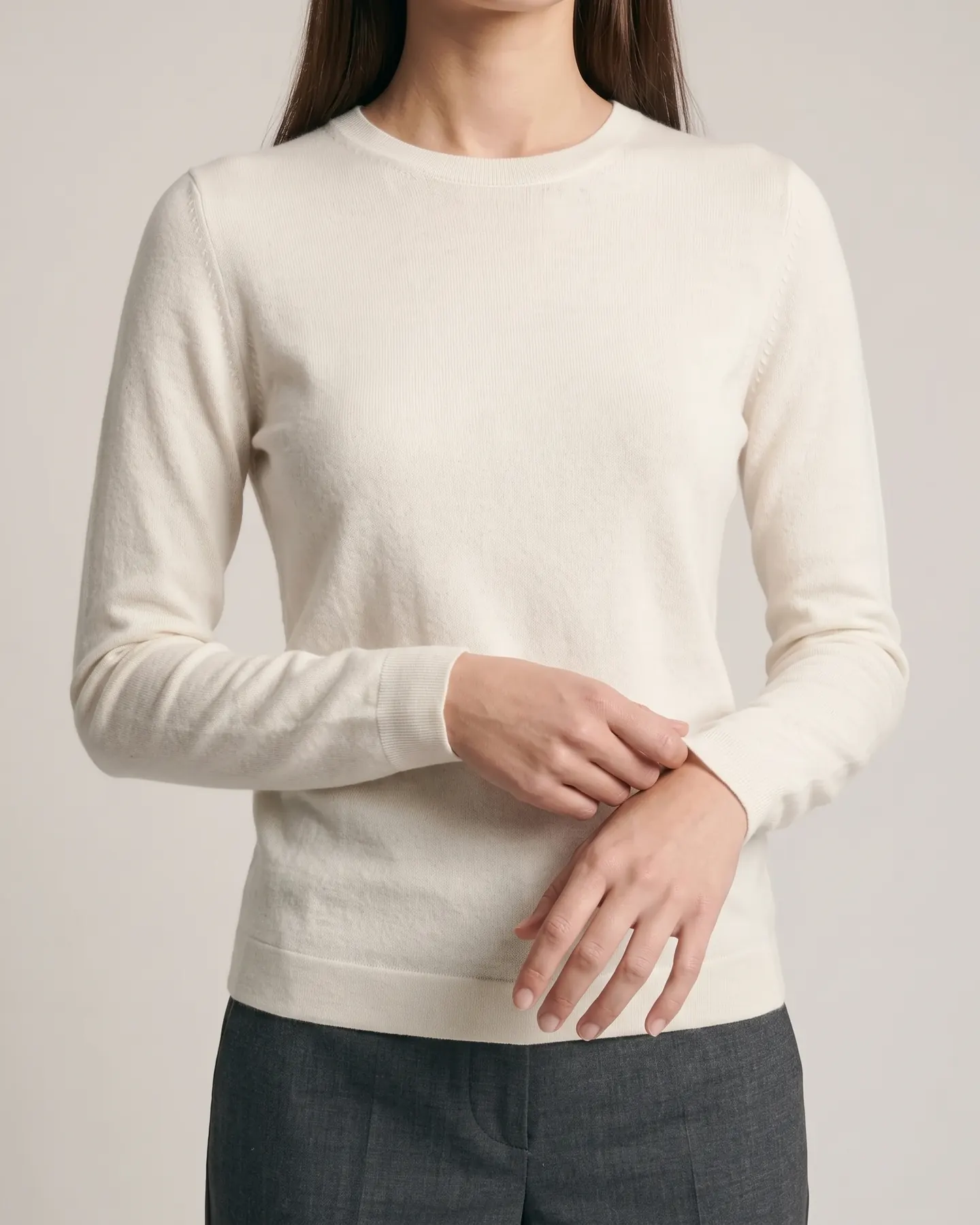 A close pass on the knit — the rib and the weave of the cream jumper